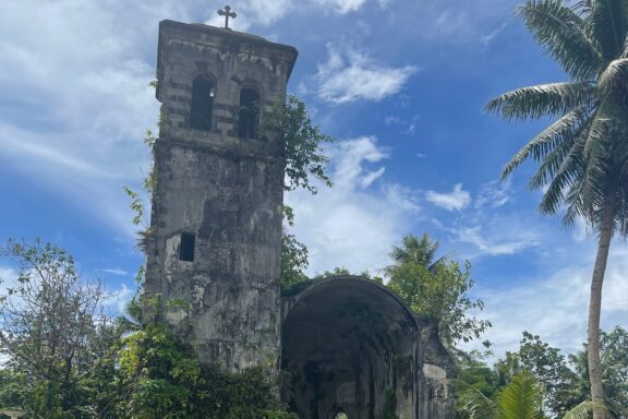 Ruined Bell Tower of an Old Cathedral with Tropical Foliage Cathedral of Ponape Belltower, a haunting glimpse into Pohnpei's colonial past