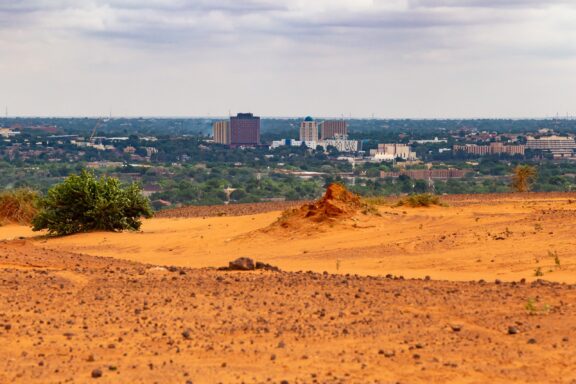 Niamey Cityscape with Sandy Foreground Niamey's skyline, emphasizing Niamey's geographical significance as a key trading hub