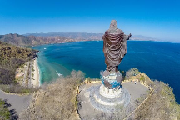 Statue Overlooking the Sea Cristo Rei of Dili towering over the city