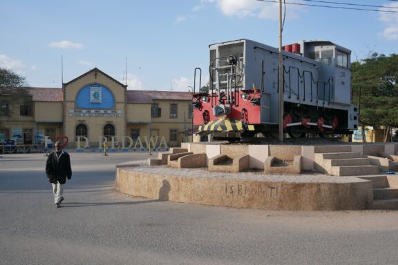 A man walks by a statue of a train in front of the old train station in Dire Dawa, Ethiopia.