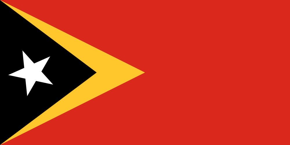 Flag of East Timor displayed with a black triangle containing a white star at the hoist and overlapping a larger yellow triangle, on a red background.