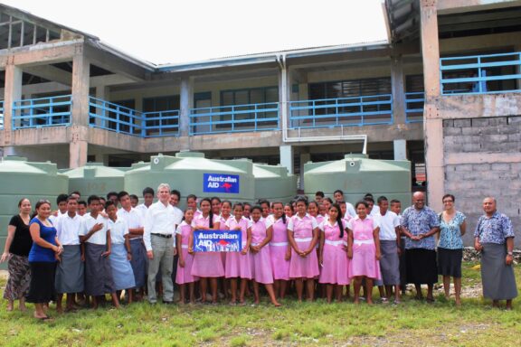 Group of People in Front of School Building The youth of Funafuti, which makes up a significant portion of the island's population