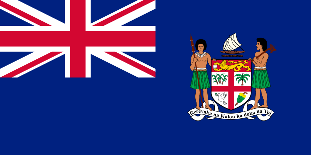 Historical flag of Fiji featuring the Union Jack in the top left corner and the Fijian coat of arms on the right side against a dark blue background.