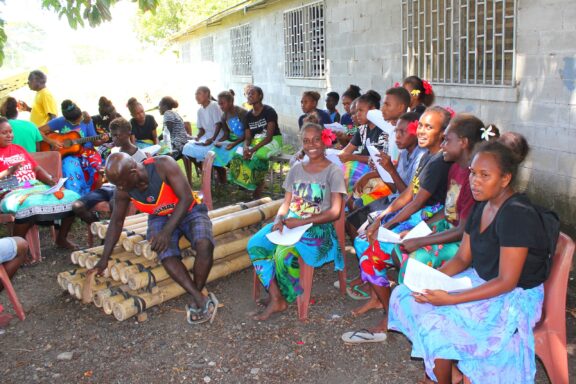 Group of People Sitting Outdoors in Honiara Locals during the annual Anzac Memorial
