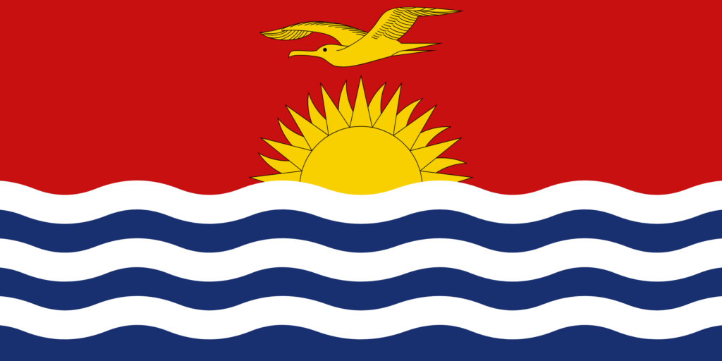 Flag of Kiribati with a yellow frigatebird flying over a rising sun on a red background above blue and white wave stripes.