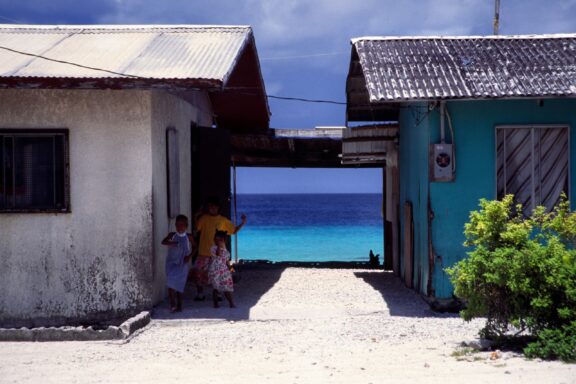 Locals Standing by Coastal Homes Local Marshallese people from Majuro