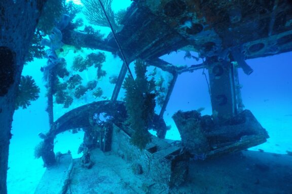 Underwater View of Sunken Shipwreck with Coral Growth Remnants of historical shipwrecks in the vast Majuro underwater world