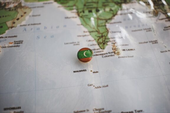 A pin with the flag of Maldives placed on Male on a map.