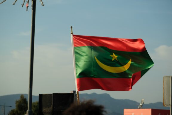 Flag of Mauritania waving against a clear sky.