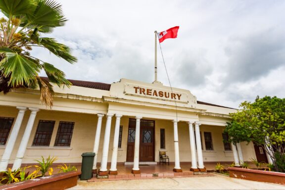 National Treasury Building Facade with Flag Historic Stone National Treasury Building, a testament to Tonga's efforts in maintaining economic sovereignty