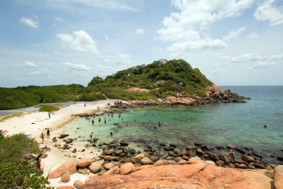 Tropical Island Beach with Visitors and Clear Waters Pigeon Island National Park, a cultural and natural treasure
