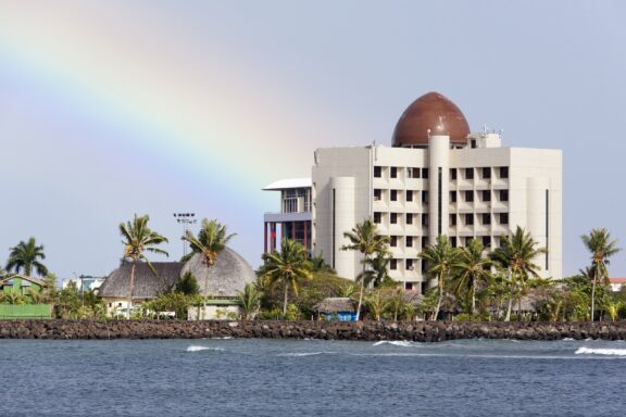 Coastal View of Samoan Cultural Village and Modern Buildings Samoa Cultural Village with the Samoan Government Building in the background