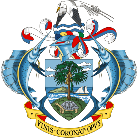 Coat of arms of Seychelles featuring a shield with a palm tree and ocean, flanked by two sailfish, with a helmet and bird above, and a banner below with the motto "Finis Coronat Opus".