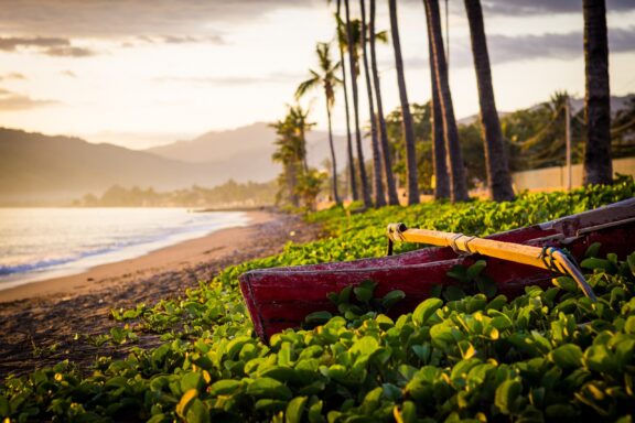 Tropical Sunrise at Dili Coast with Canoes Sunrise at the sandy beaches on the coast of Dili