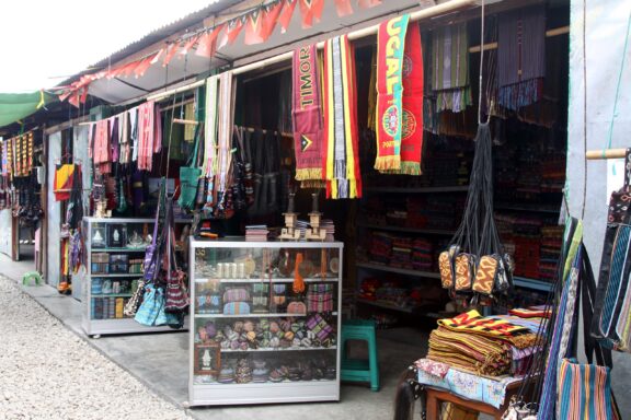 Outdoor Market Stall Displaying Textiles and Souvenirs Tais Market, specializing in traditional textiles