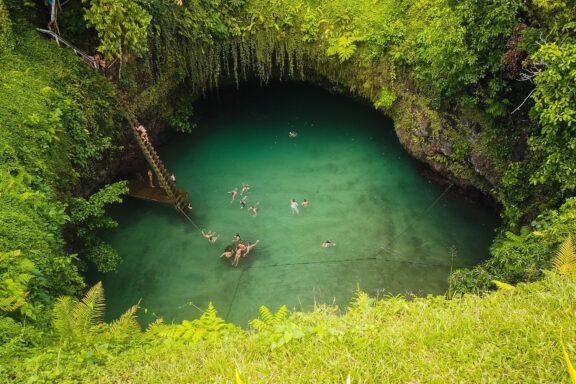 Swimmers in To Sua Ocean Trench, Samoa Sua Ocean Trench, a natural swimming hole