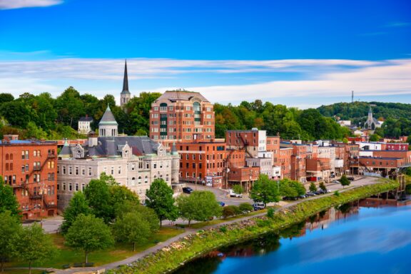 A view of the Augusta, Maine skyline from across the water on a clear day.