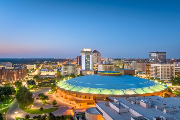 An aerial view of the Century II building in central Wichita, Kansas at twilight.