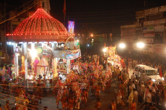 Many people celebrate with a parade at night in Muzaffarnagar, India.