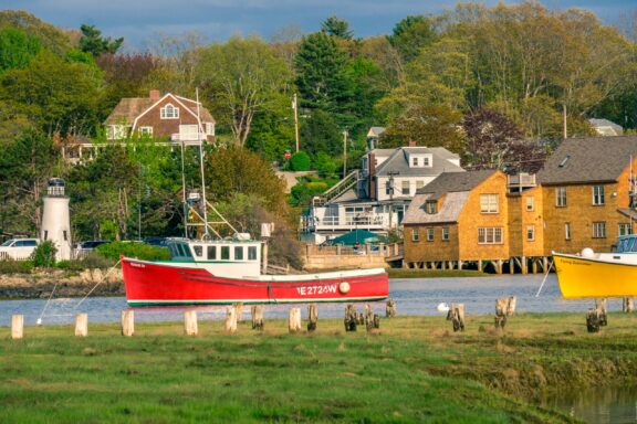 Red and yellow boats sit in the water at Kennebunkport, Maine in York County.