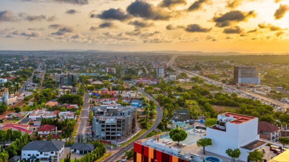 Sunset Over Accra: A Panoramic View of Ghana's Vibrant Capital City An aerial view of the city of Accra during golden hour.
