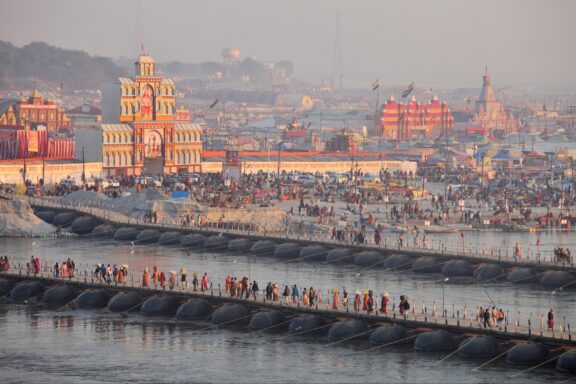 Many people cross pontoon bridges over the Ganges River in Allahabad, India.