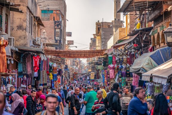 A busy street overflowing with people in Cairo, one of the safest cities in Africa.