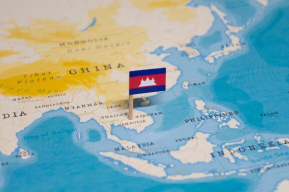 A pin with the flag of Cambodia placed on a map, indicating the country's location.