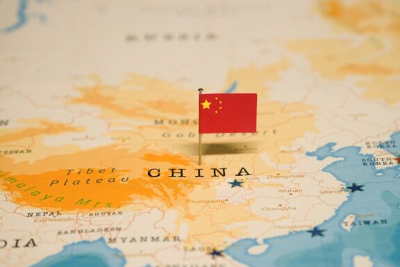 A map pin with the flag of China placed on a map at the location of China.