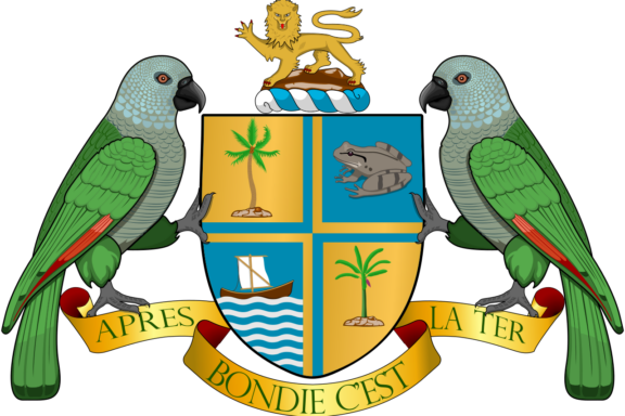 Coat of arms of Dominica featuring a shield with a lion, palm trees, a frog, and a ship, flanked by two Sisserou parrots with a banner below.