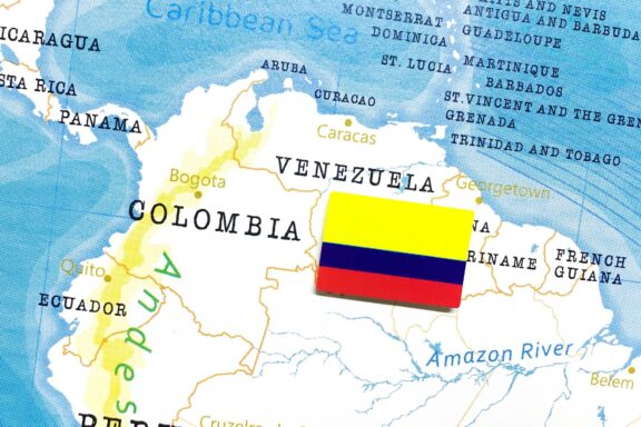 Map of Colombia with the Colombian flag overlaying the country's borders.