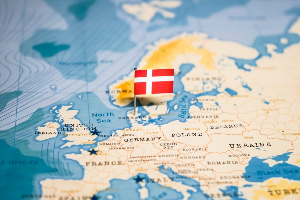 A Denmark flag pin placed on Copenhagen on a map.