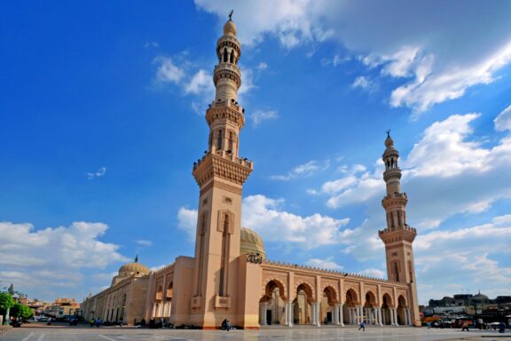 A low-angle view of the el-Badawi Mosque in Tanta, Egypt under blue skies.