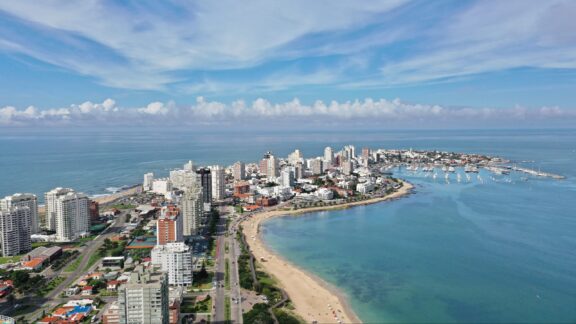 Aerial Panoramic View of Punta del Este, Uruguay, Showcasing Beaches, Skyscrapers, and Marina An aerial view of Punta del Este, Uruguay and the surrounding water.