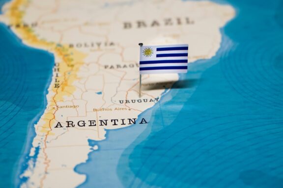 Uruguay flag pin placed on Montevideo on a map, highlighting its geographic location.