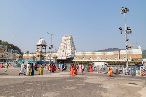 People gather outside one of a large temple in Tirupati.