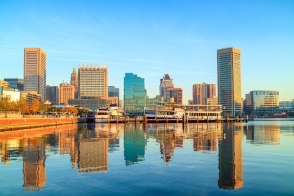 Buildings reflect in downtown Baltimore’s Inner Harbor.