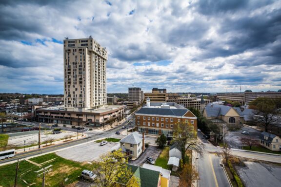 Buildings stand under a cloudy sky in Towson, Maryland.