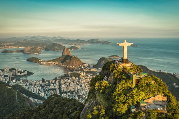 An aerial view of Sugarloaf Mountain and Rio de Janeiro just before sunset in Brazil.