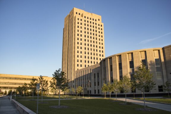 A low-angle view of the North Dakota State Capitol building in Bismarck.