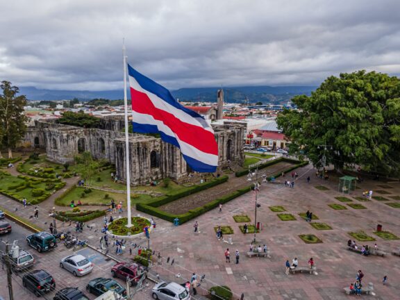 An aerial view of a large Costa Rican flag waving in the wind in Cartago, Costa Rica.