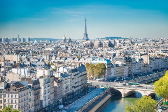 An aerial view of the city of Paris, France, with the Eiffel Tower visible in the distance.