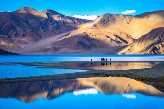 Mountains reflect in the waters of Pangong Lake in Leh, Ladakh.