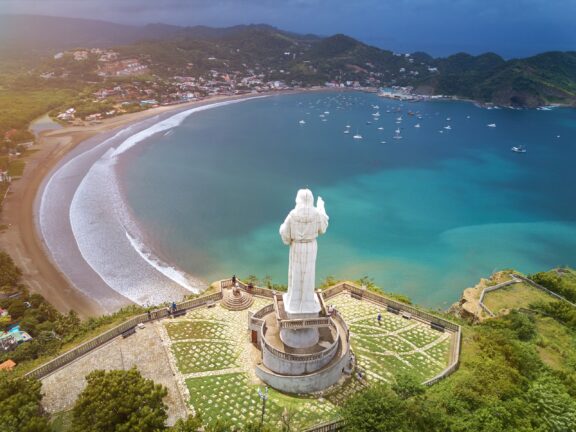 An aerial view of a statue of Jesus Christ atop a hill in San Juan del Sur, Nicaragua.