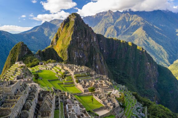 A view of Machu Picchu and the surrounding green mountains in Peru. 