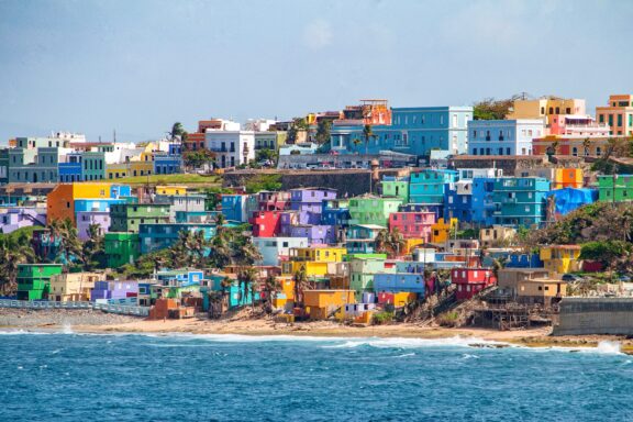 Colorful houses sit on a hill overlooking the sea in San Juan, Puerto Rico.