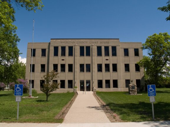 A low-angle view of the front of the Sheridan County Courthouse in McClusky, North Dakota.