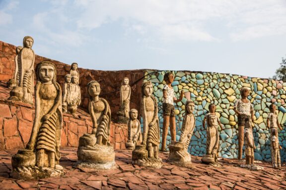 Several stone statues stand in the sun at Chandigarh’s Rock Garden.