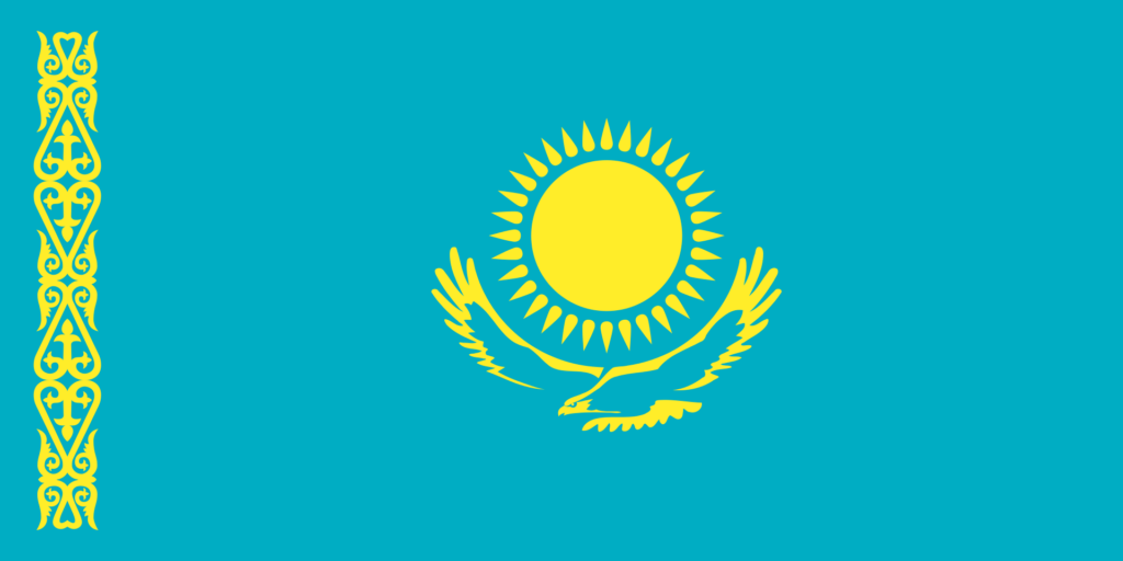 Flag of Kazakhstan with a sky blue background, a golden sun with 32 rays above a soaring golden steppe eagle, and a vertical band of traditional Kazakh patterns on the hoist side.