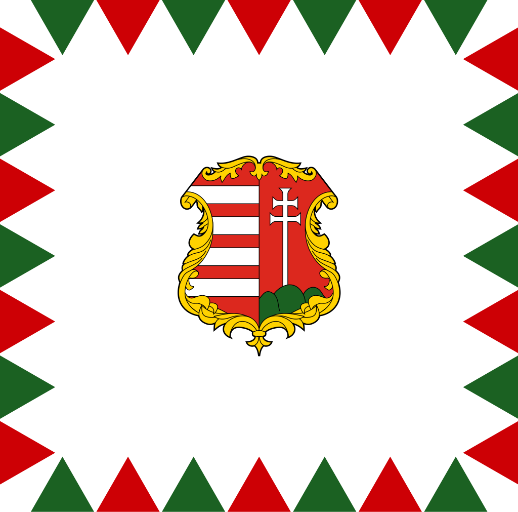 Coat of arms with red and white stripes and a white cross on a green hill, surrounded by a decorative gold frame on a patterned background with red, white, and green triangles.